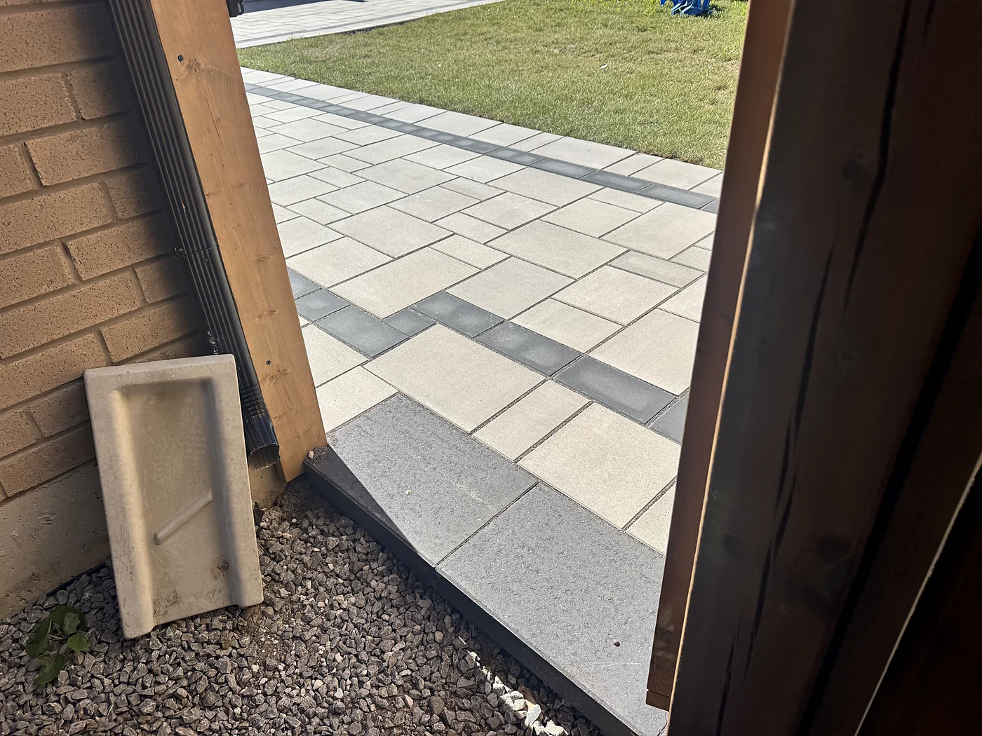 Completed paving border and transition detail in the featured backyard project